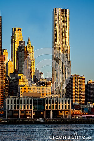 Vertical sunrise view of lower Manhattanâ€™s skyline featuring Frank Gehryâ€™s 8 Spruce Street Editorial Stock Photo